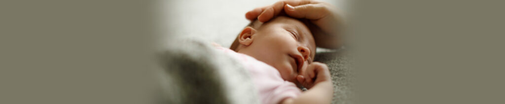 Hand on baby's head