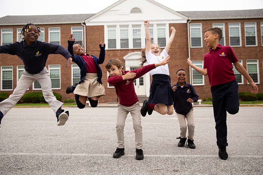 Students at Bethel Christian Academy are seen jumping outside