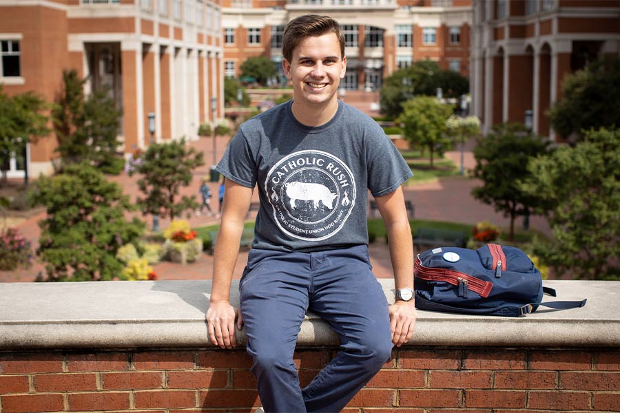 Jack Denton is seen sitting on a wall on the campus of Florida State University