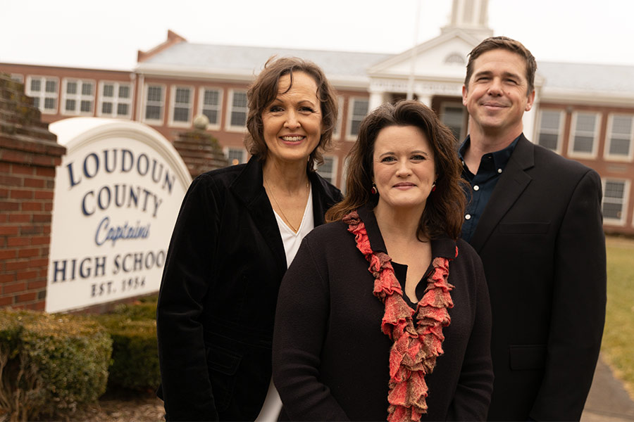 Kim Wright, Monica Gill, and Tanner Cross stand outside Loudoun County High School