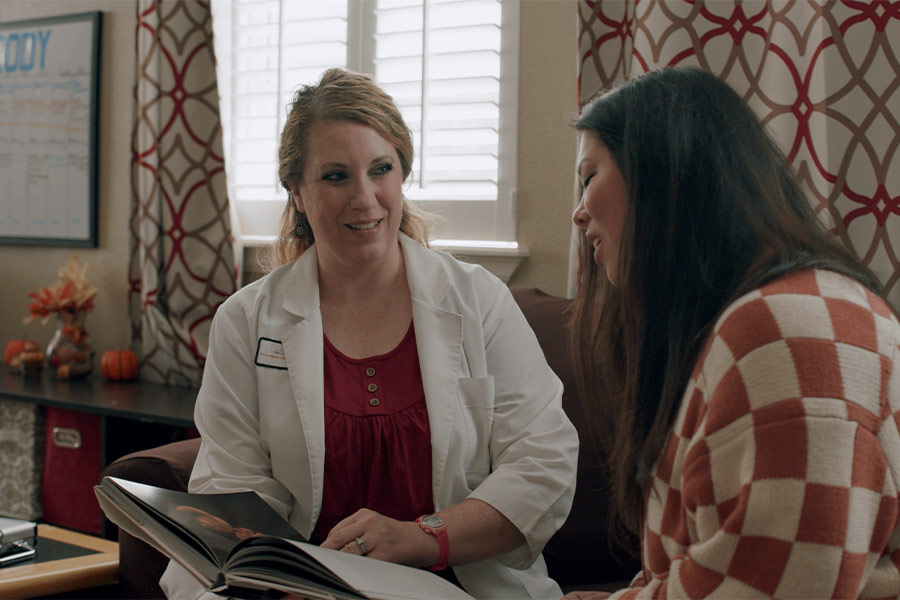 Chelsea Mynyk (L), licensed nurse practitioner and certified nurse midwife, owner of Castle Rock Women's Health, with a patient.