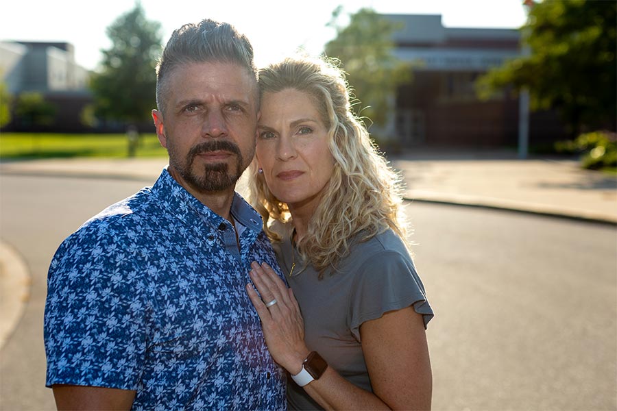 Dan and Jennifer Mead stand together outside East Rockford Middle School