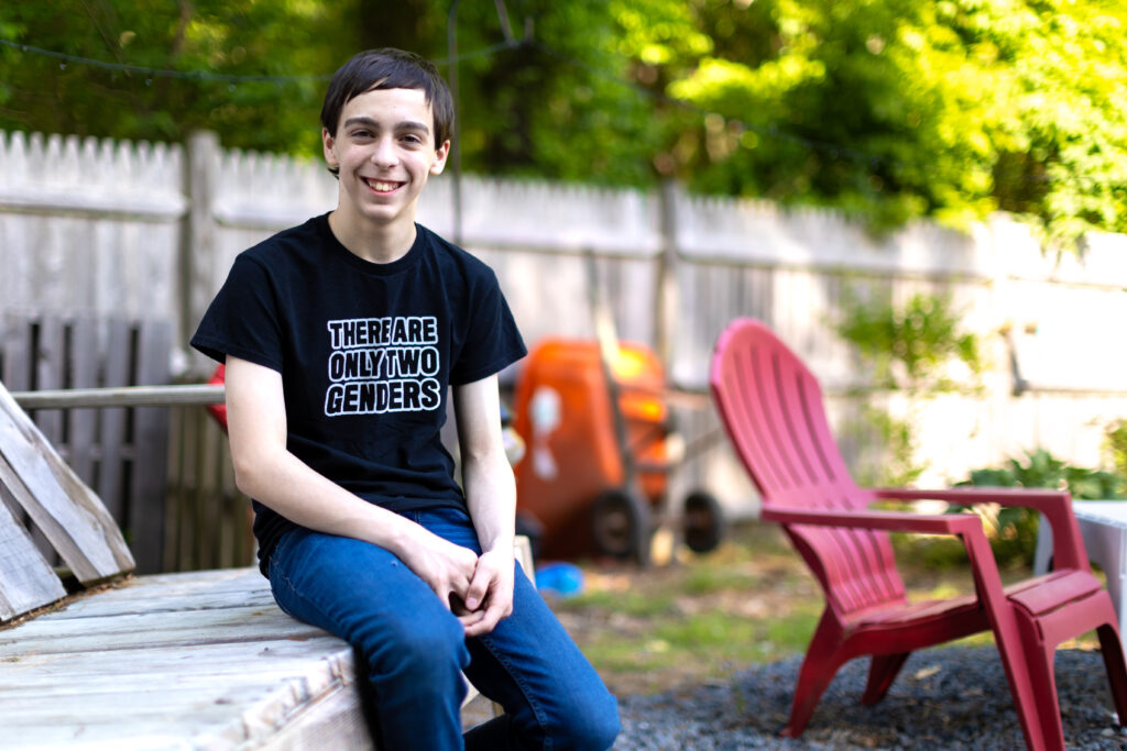 Liam Morrison smiling, sitting outdoors